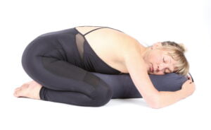 Childs pose with bolster to relieve anxiety
